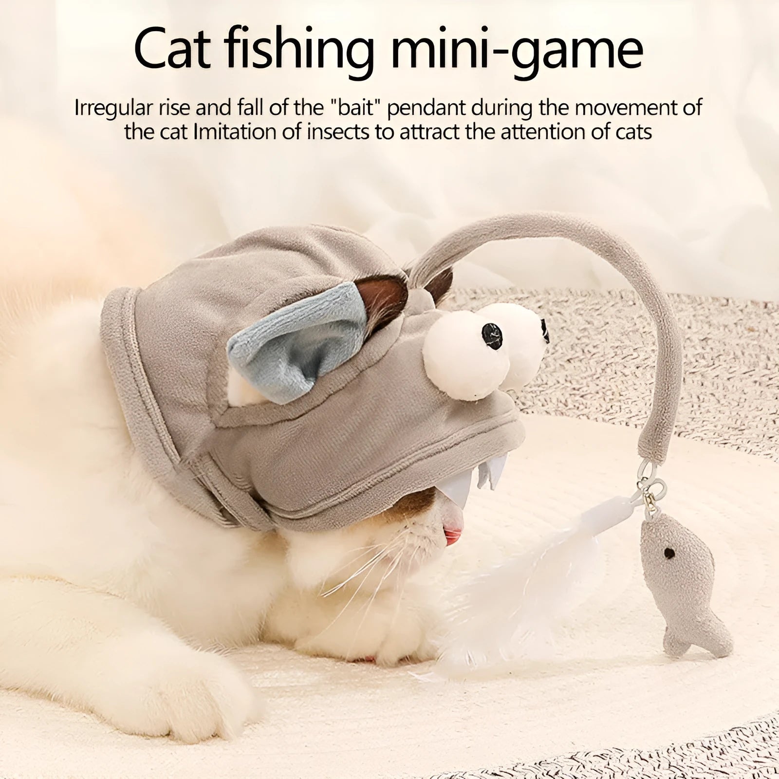 Grey head-mounted cat toy with feather and big-eye fish attachments on adjustable elastic band