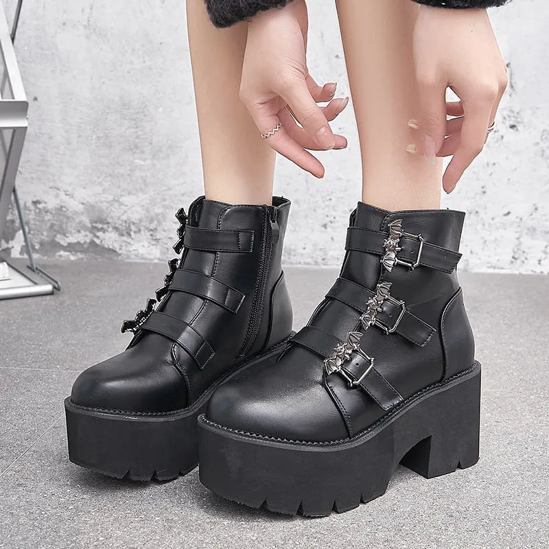 Black women's punk gothic ankle boots with bat buckle, side zip, and thick heel.