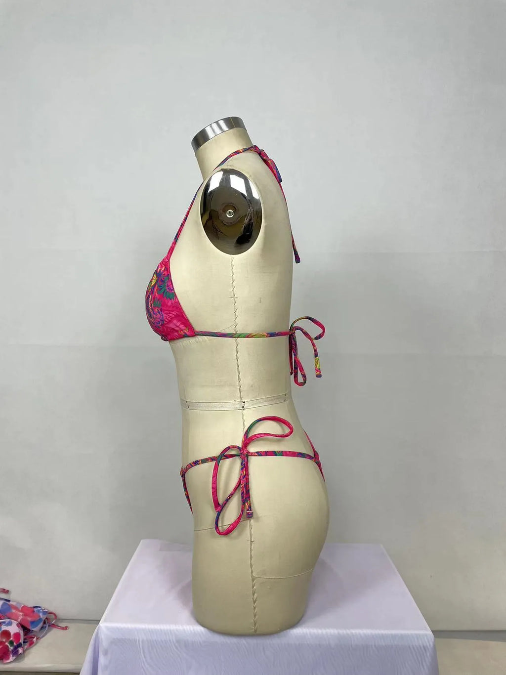 Pink women's nylon bikini two-piece set with triangle top and briefs for swimming.