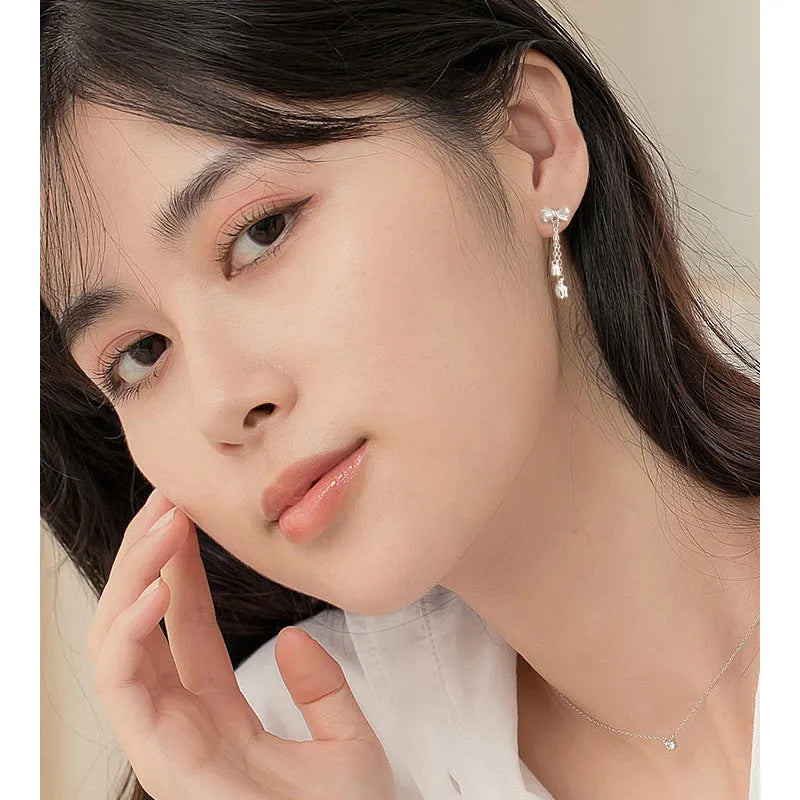 Silver bow eardrops with sweet tassel bone stud design for women