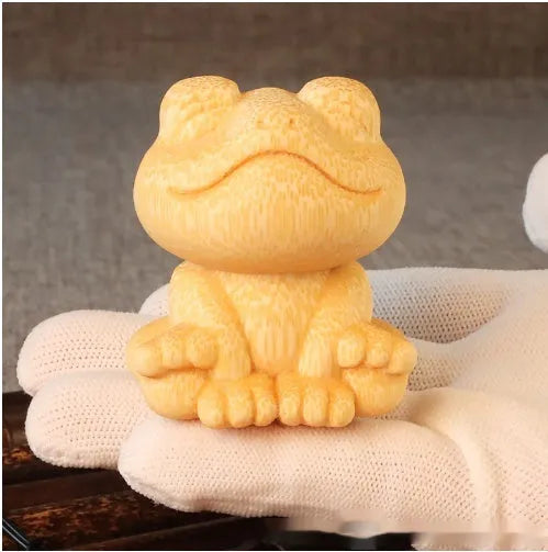 Solid bamboo smiling frog carving ornament measuring 5cm high with 120ml oil glove brush.