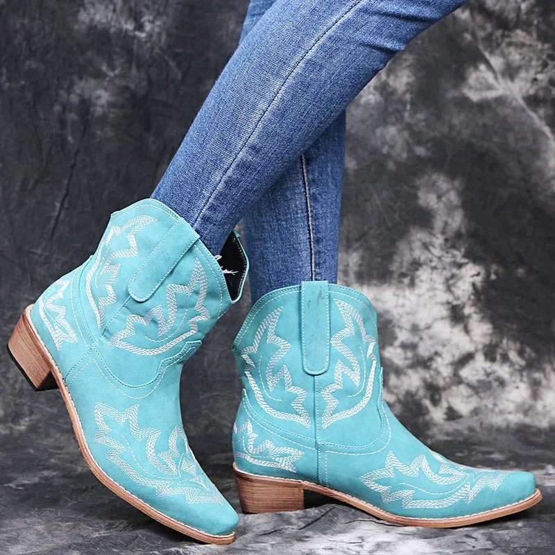 Blue embroidered women's cowgirl boots with a low wedge heel and pointed toe.