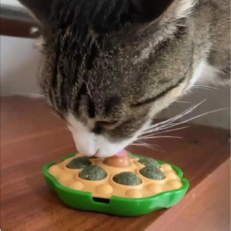 Green lotus-shaped adhesive catnip ball toy for cats, shown with dimensions approximately 10.5cm.