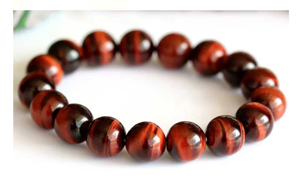 Wooden Tigereye bracelet with Lightning Cat's Eye design on wrist, showing geometric round beads.