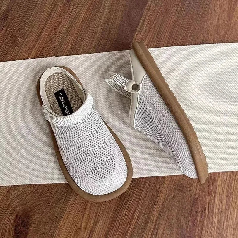 Beige linen slip-on shoes with mesh lining and a light rubber sole on a neutral background.