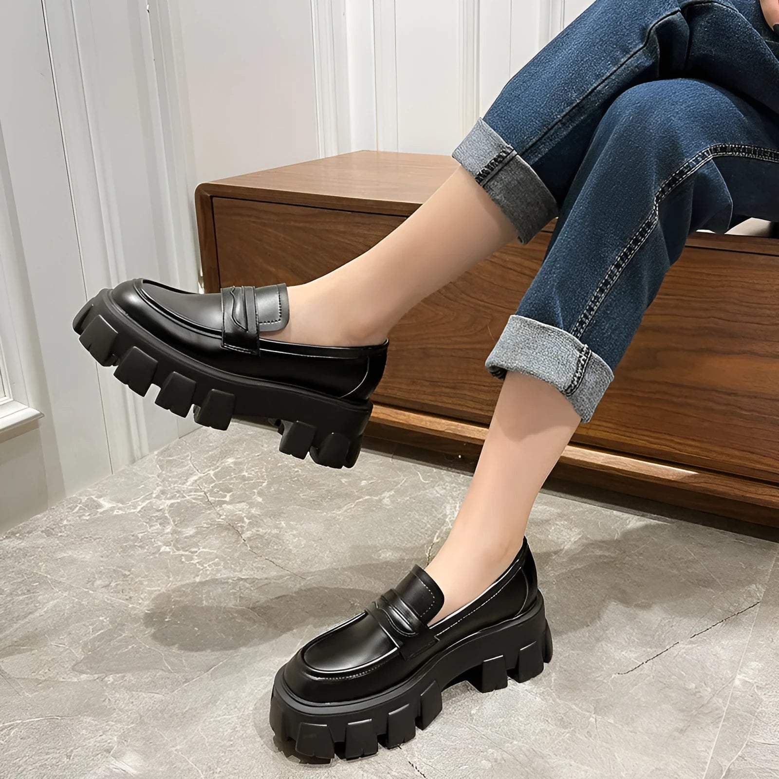 A pair of British style wide fit loafers in patent leather with a rubber sole.