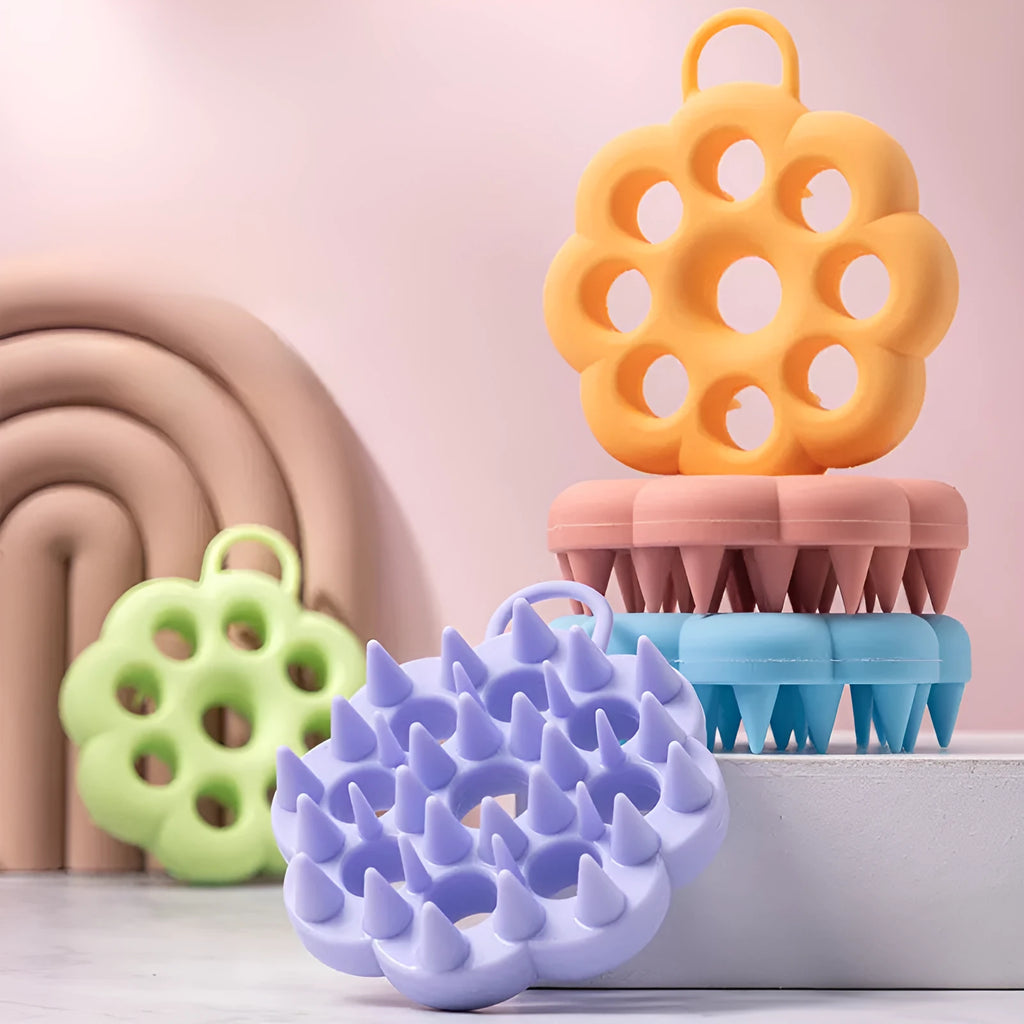 Silicone pet grooming brush in multiple colours for dogs and cats, showing flexible bristles.