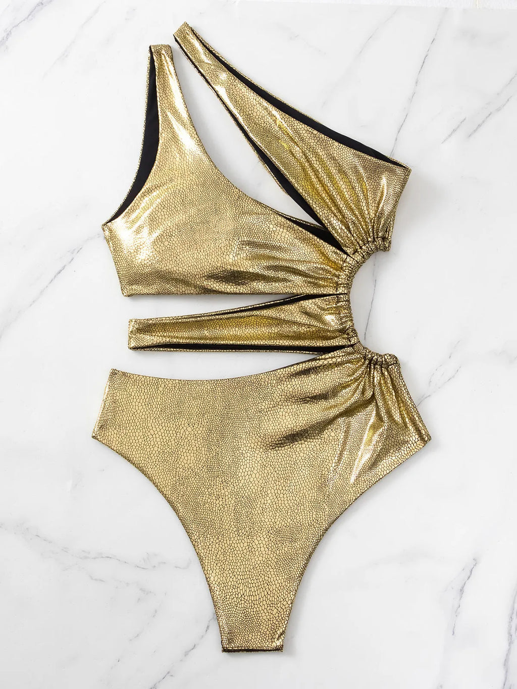 Women's solid gold backless one-piece swimsuit on a white background.