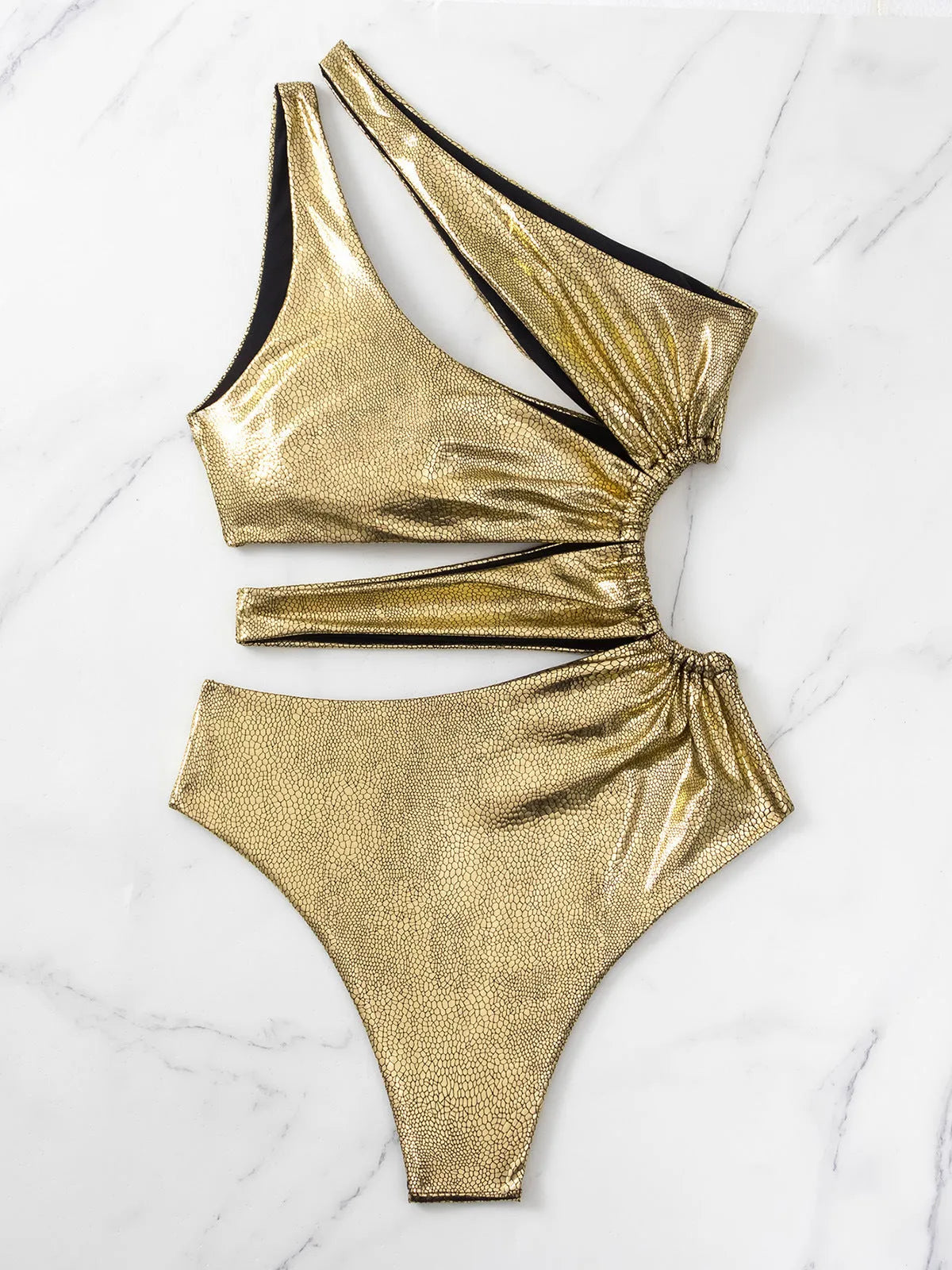 Women's solid gold backless one-piece swimsuit on a white background.