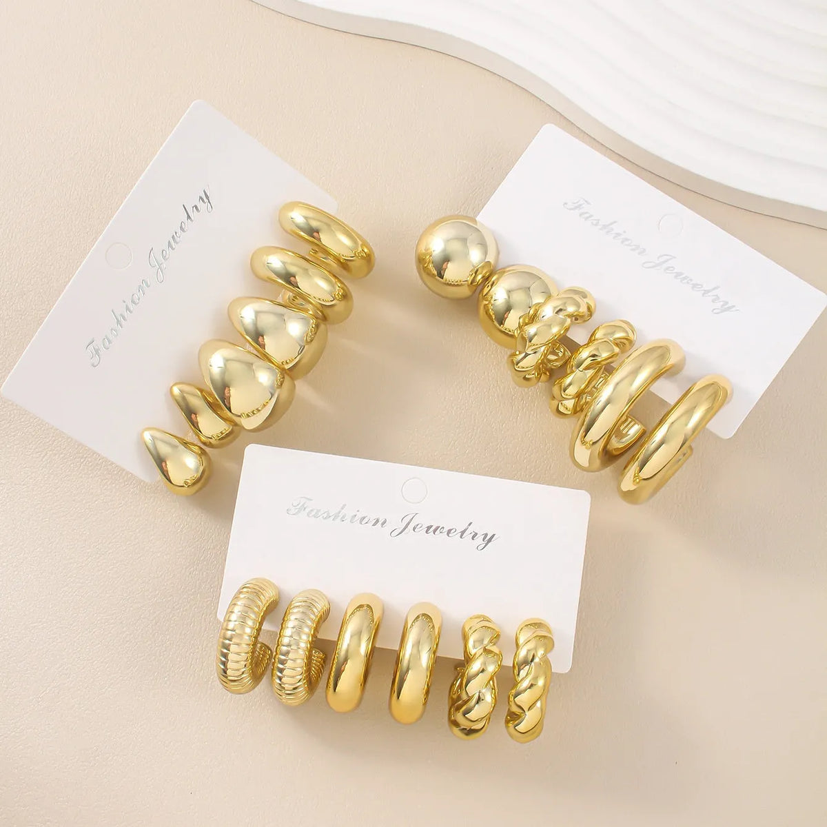 Three pairs of gold, silver, and black acrylic geometric double circle drop earrings set