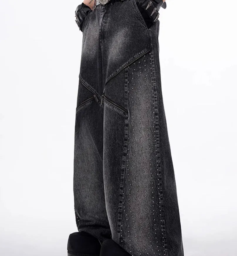 Black and grey washed denim wide leg trousers with structural zipper detail and matching vest, laid flat.