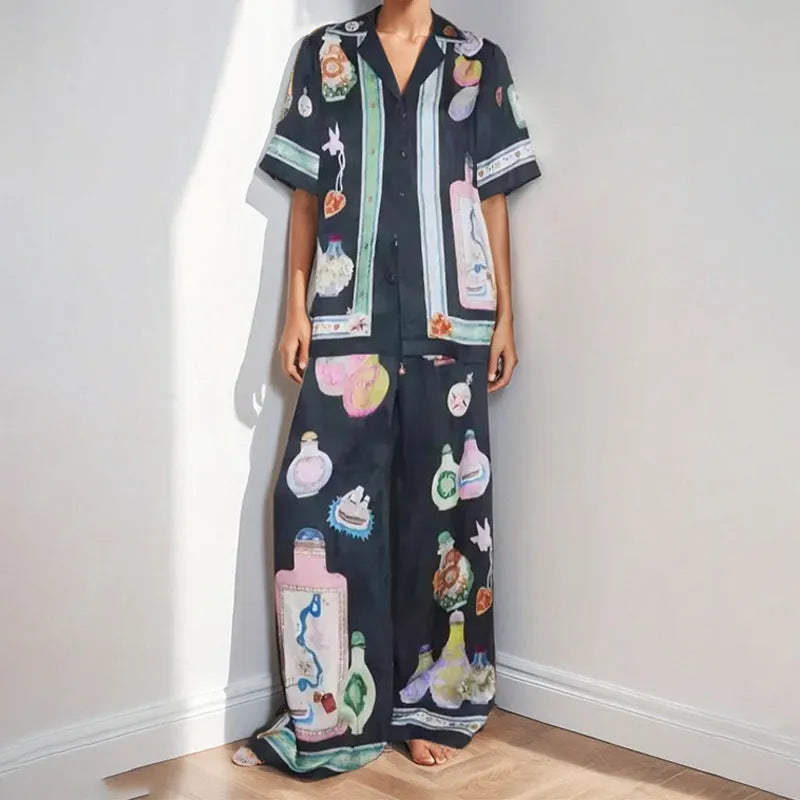 Black women's casual two-piece set with cartoon print, featuring cardigan and matching pants.