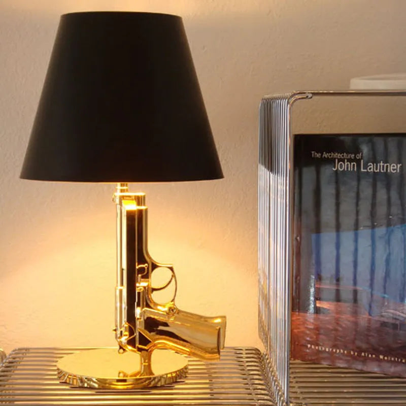 Nordic style creative desk lamp with plated gold resin base on a wooden desk