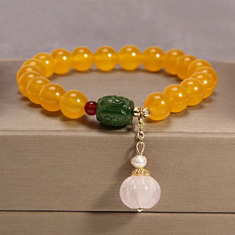 Khaki women's bracelet with yellow agate crystals threaded on a gold silk cord.
