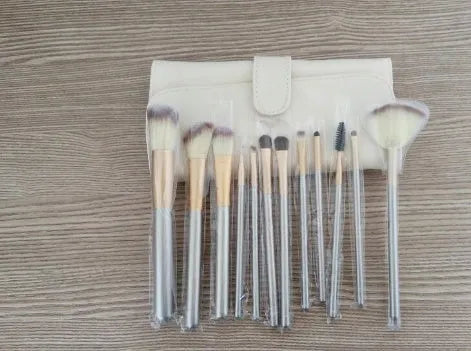 Persian makeup brush set with rice white bristles and champagne handles, showing multiple brushes.