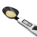 Digital kitchen measuring spoon with LCD screen showing weight measurement