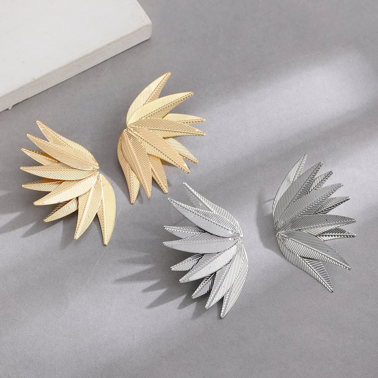Gold and white leaves patch earrings with detailed leaf design made from alloy metal