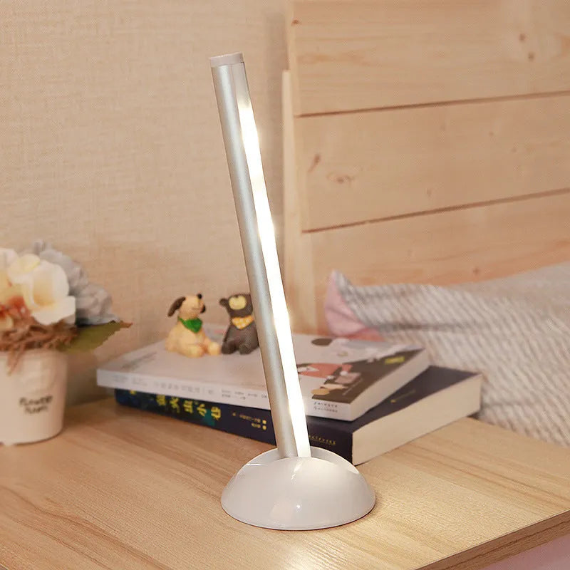 White plastic LED night light with remote control on a cabinet door.