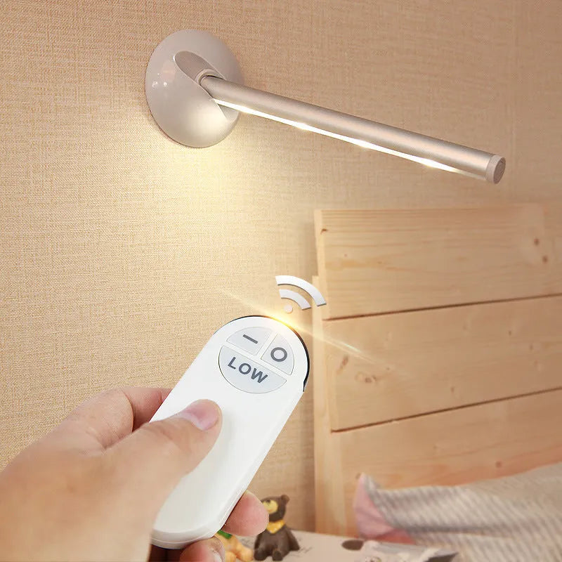 White plastic LED night light with remote control on a cabinet door.