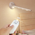 White plastic LED night light with remote control on a cabinet door.