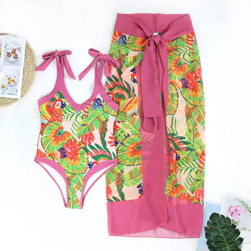 Retro pink floral print one-piece swimsuit with V-neck, thin skirt, and covered belly design.