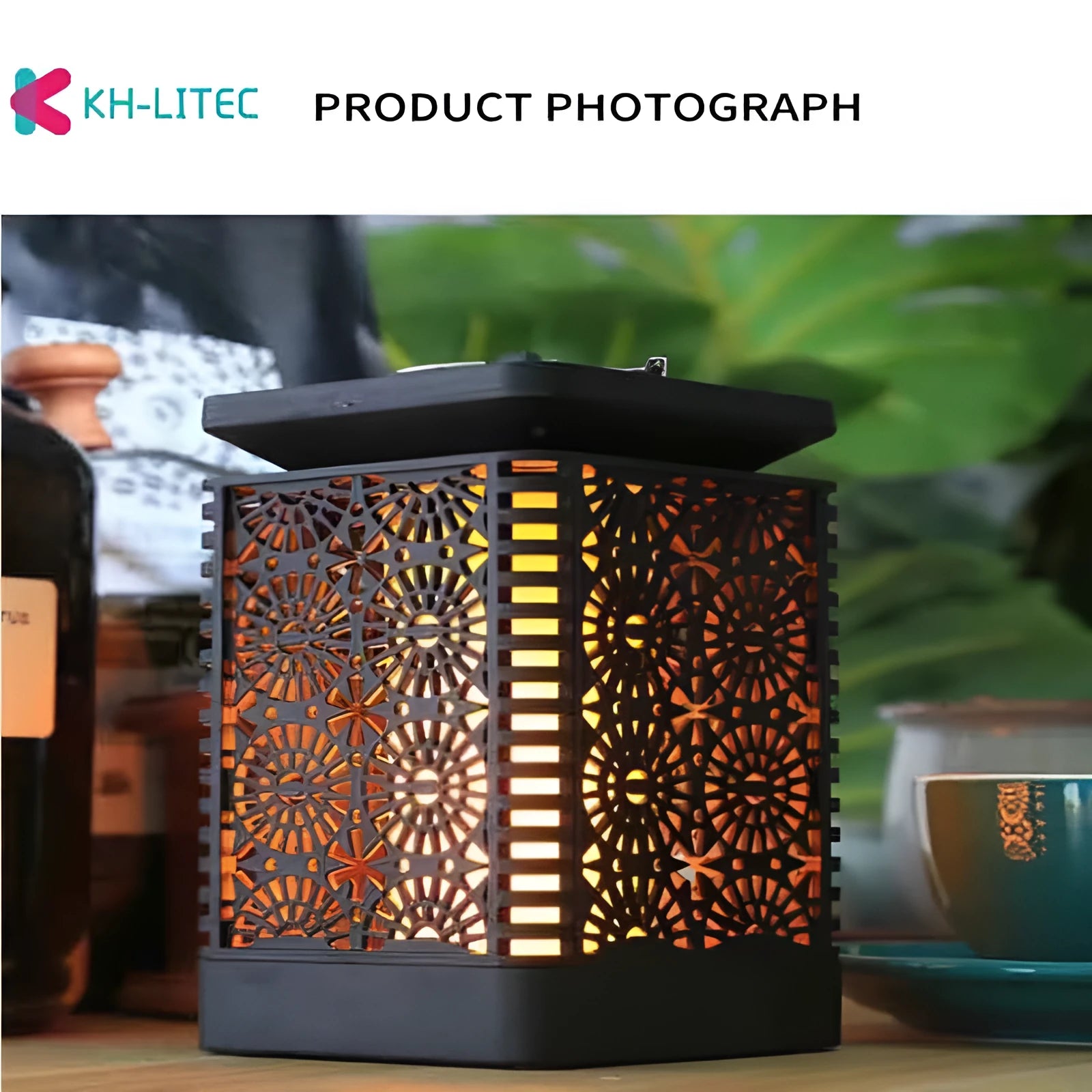 Four black solar-powered hanging torch lights with flame-effect LEDs for outdoor garden decoration.