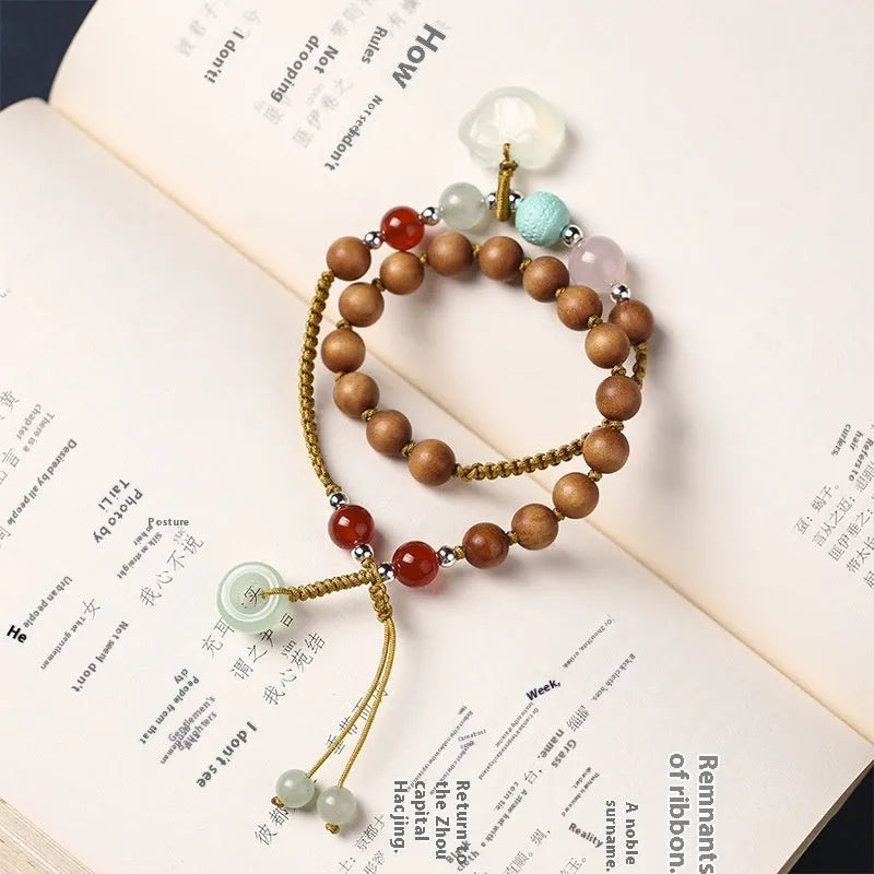 Women's ebony double ring bracelet with hand-woven construction and traditional Ruyi design elements