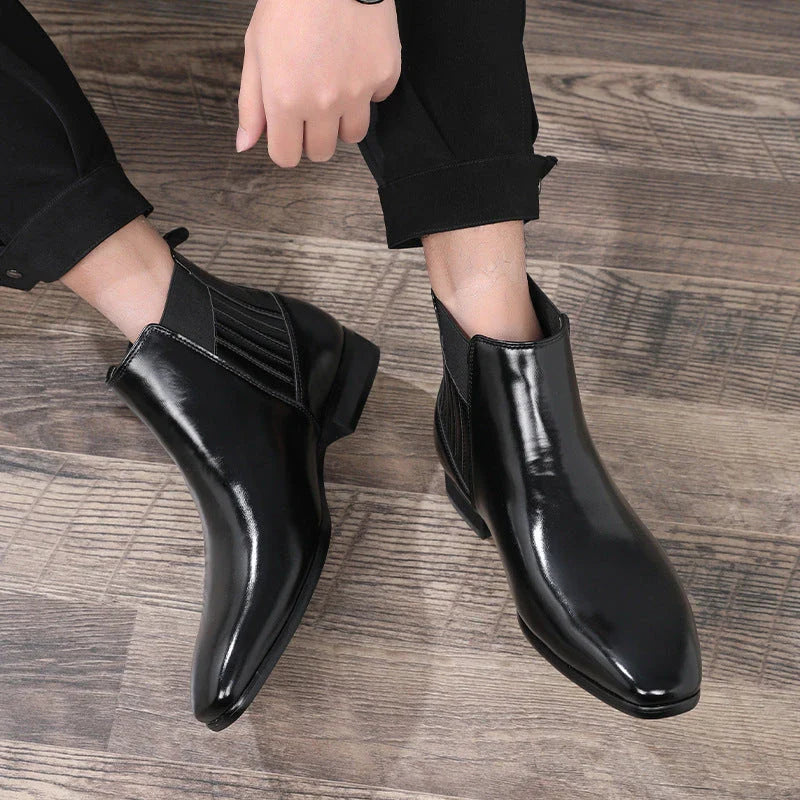 Stylish pointed-toe Chelsea boots for men in black and brown colors, featuring a square heel and sleek, British-inspired design.