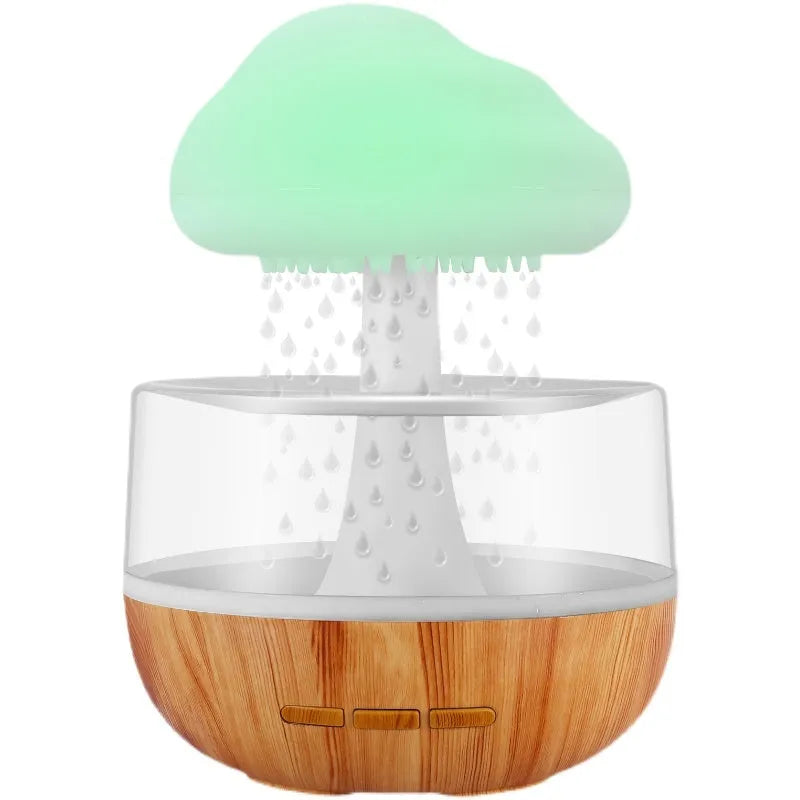 White cloud-shaped humidifier with LED night light and water droplet effect on a table.