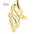 Gold coloured women's ring with exaggerated curved design on copper band