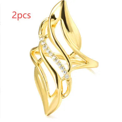 Gold coloured women's ring with exaggerated curved design on copper band