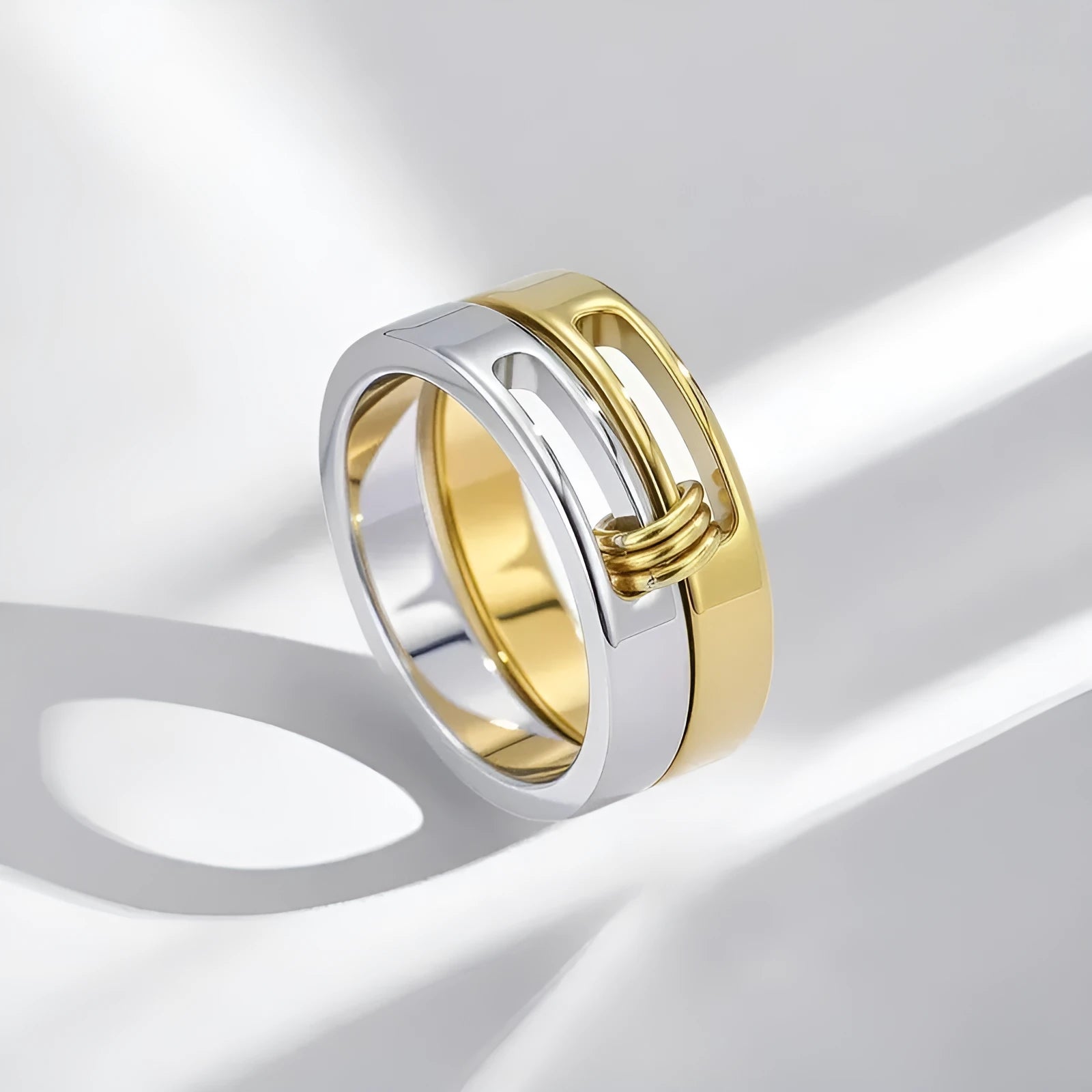 Gold double-layer twin ring made of titanium steel on a plain background