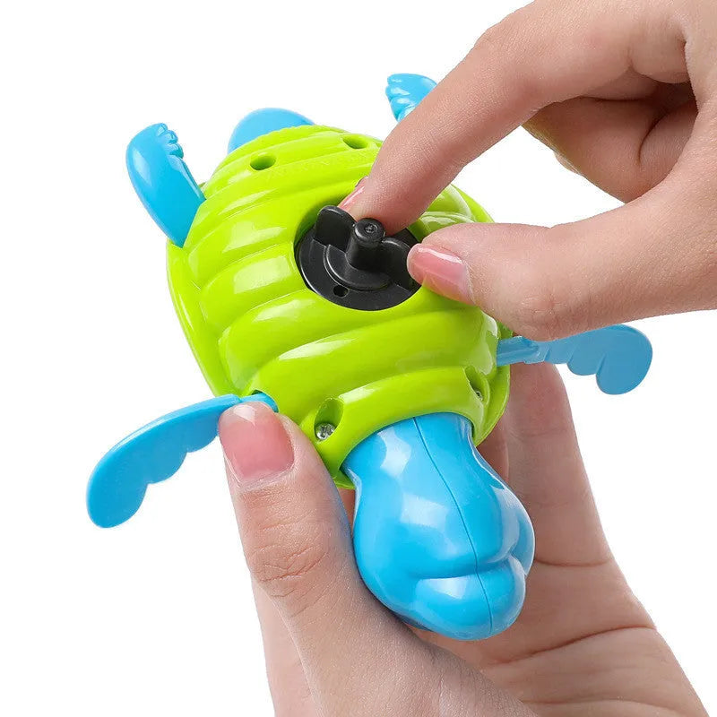 Plastic green turtle baby bath toy floating in water.