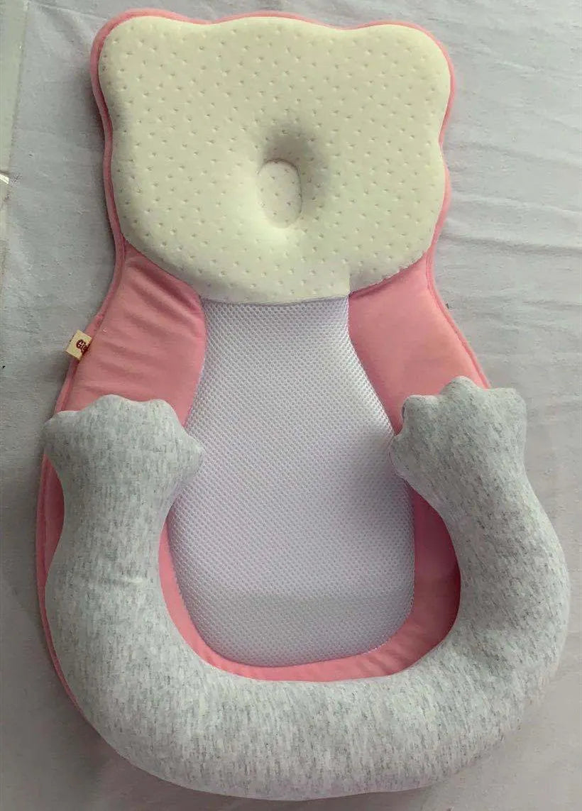 Folded portable baby travel bed with a soft beige cotton sleep cushion for newborns