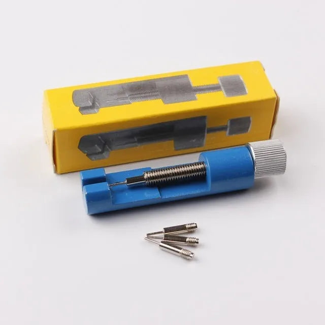 Gold metal watch link remover tool on white background, 6.4cm long, with three small thimbles