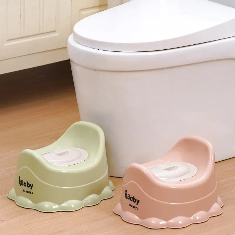 Children's portable thickened toilet in green, pink, and blue with lid option on a white background