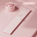 Plastic elastic resistance band in green, beige, orange, and pink colours for fitness training