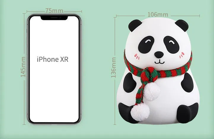 Panda-shaped silicone night light with USB cable on a table.