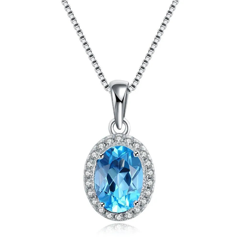 Geometric sterling silver jewellery set with blue topaz gems including earrings, ring, pendant and necklace