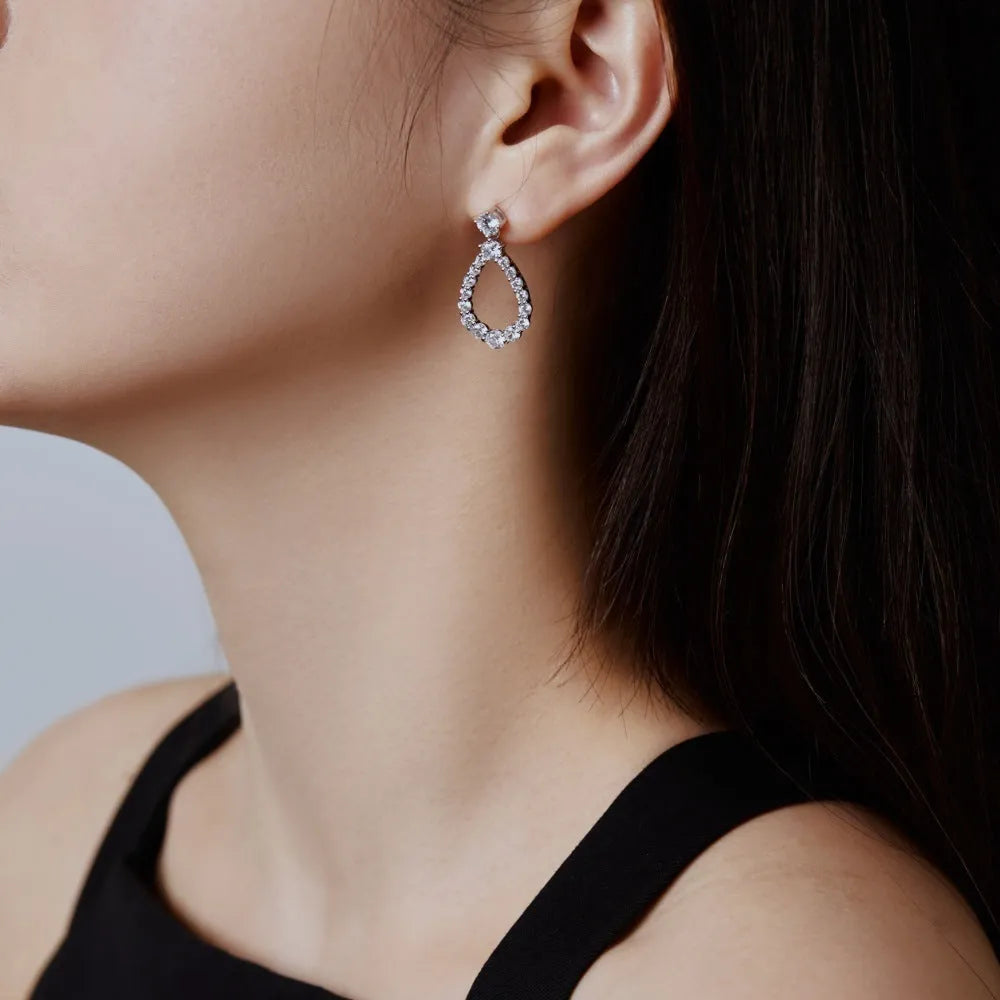 925 silver hollow zircon water drop earrings for women, platinum electroplate finish, 15 x 28.5mm teardrop shape on black background