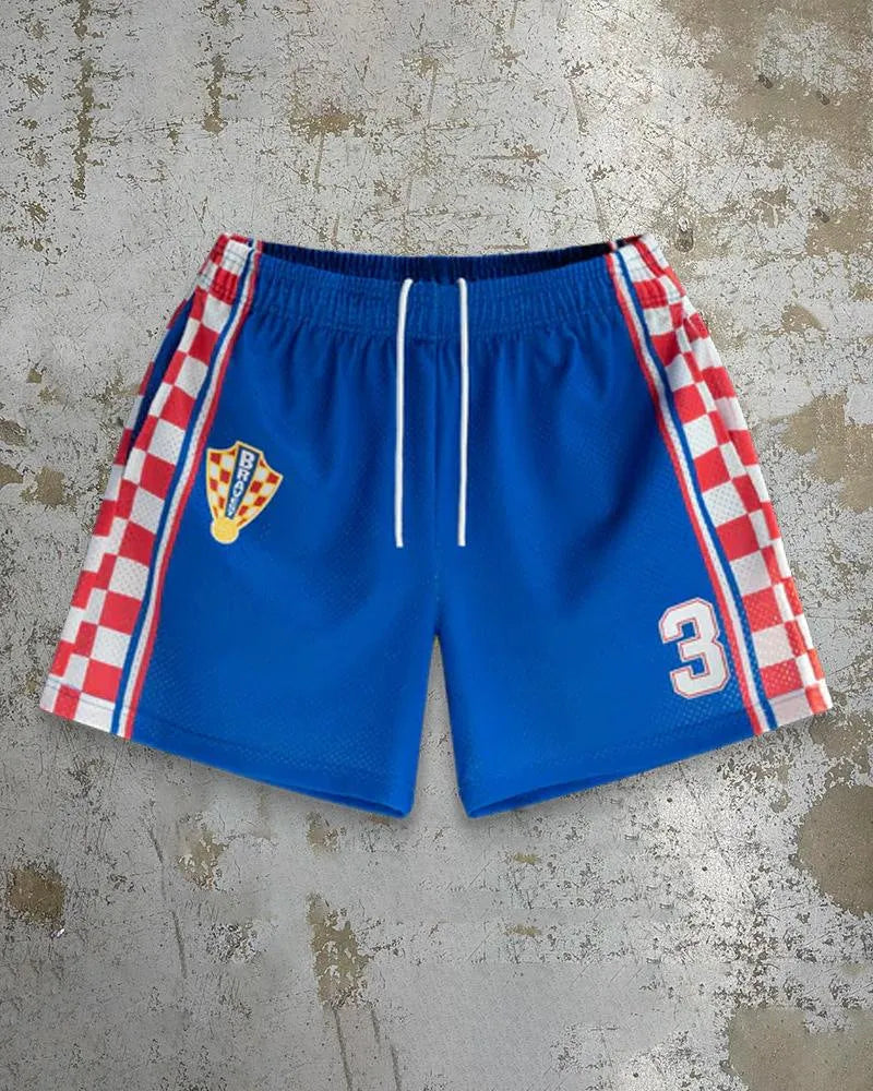 Man wearing loose-fitting quick-dry beach shorts with a digital print pattern in a summer setting.