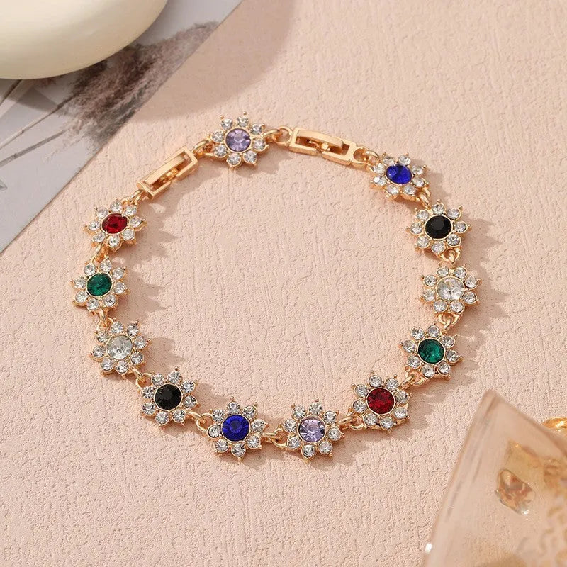 Luxury style bracelet with coloured gems and floral design on zinc alloy with electroplated finish