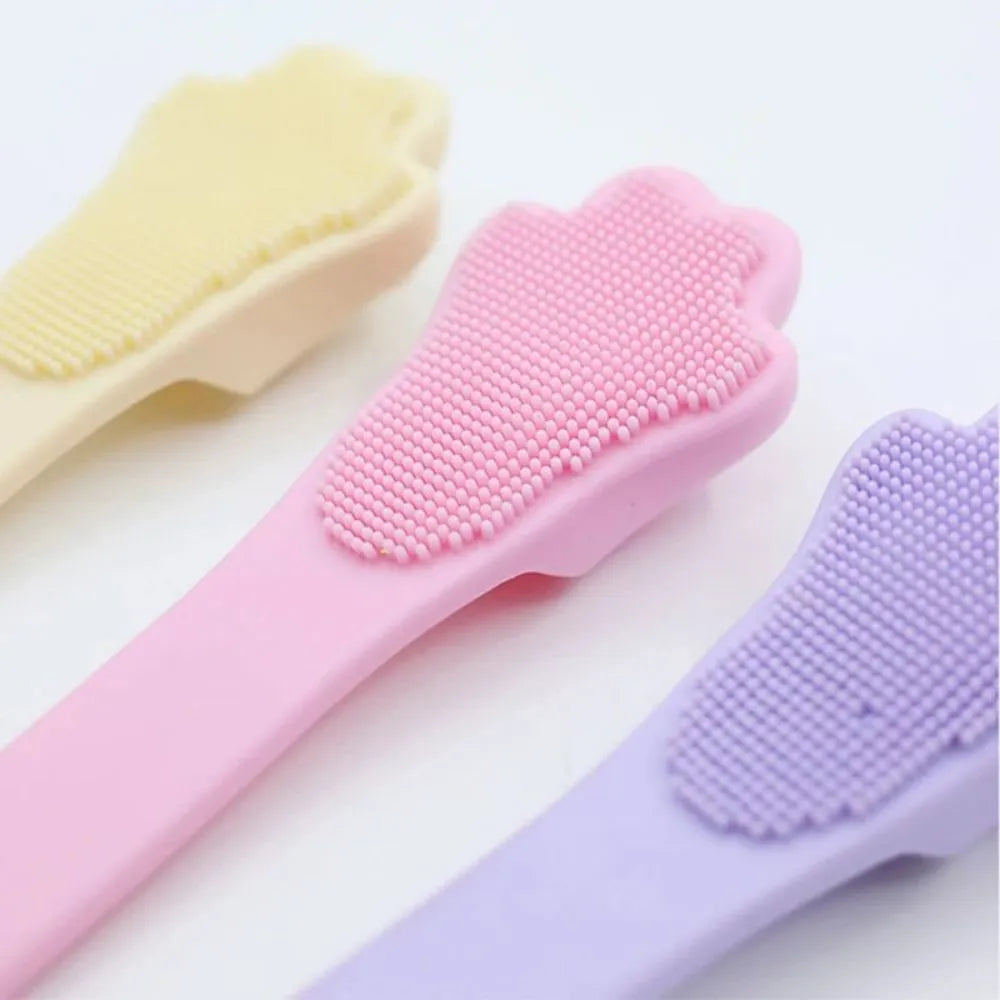 Silicone fingertip toothbrush for pets in pink, purple, and yellow, shown on a finger.