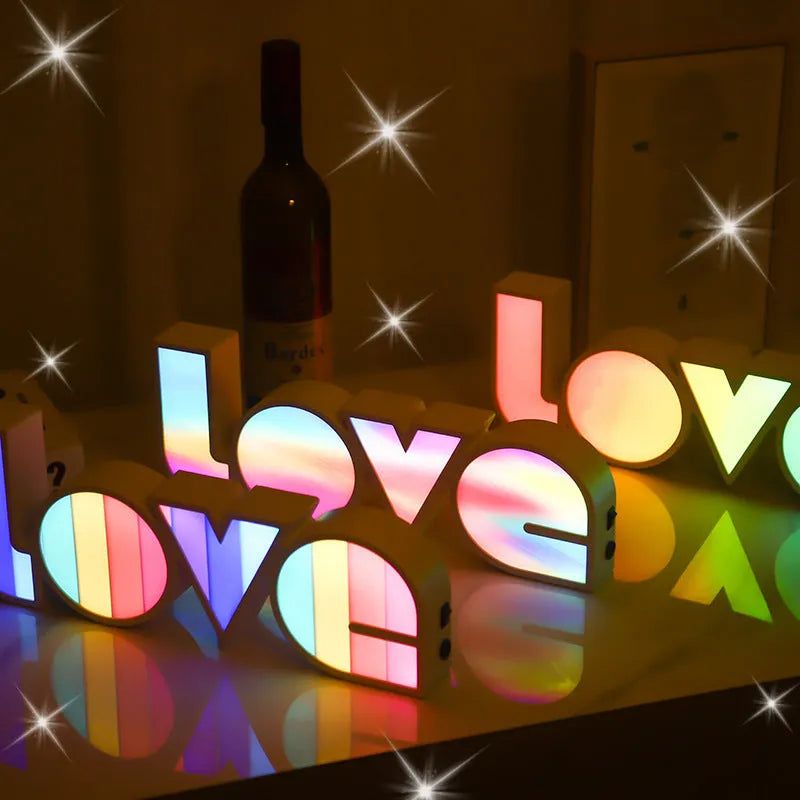 Rainbow-style plastic LED LOVE light decoration for Valentine's Day and weddings.