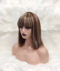 Full Mechanic 4 27 Bob human hair wig in brown with straight bangs, medium length on a mannequin head