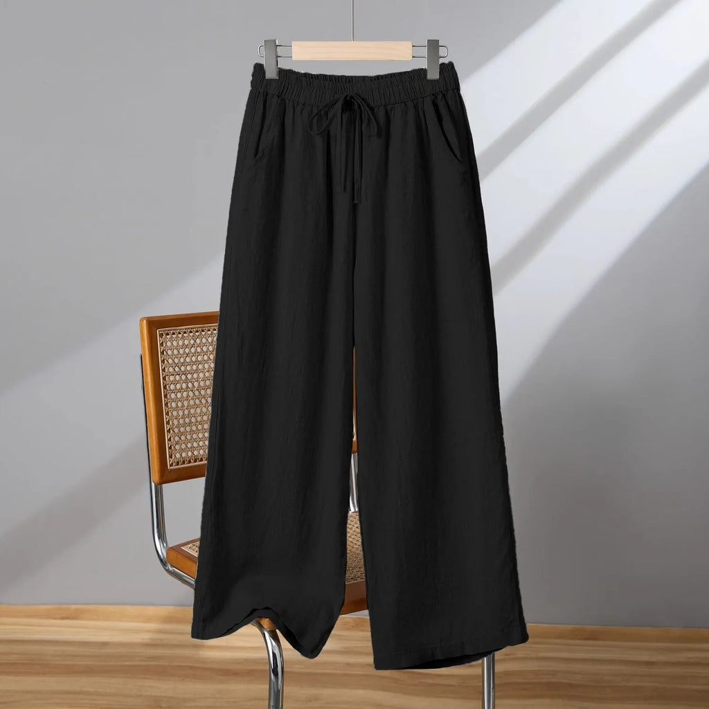 Women's straight leg casual trousers in apricot colour with an elastic waistband and lace-up drawstring detail.