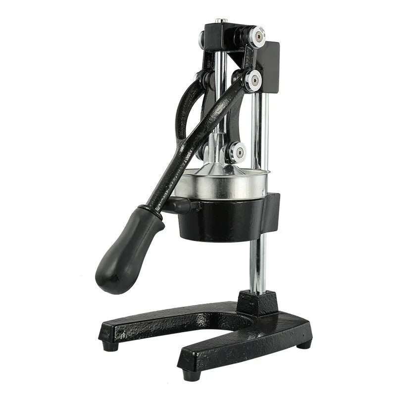 Tall black cast iron manual juicer with stainless steel cone on a kitchen counter