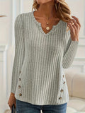 A simple solid colour knitted pullover sweater with button detailing on the front.