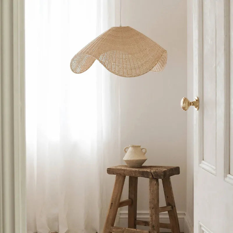 Handmade natural bamboo rattan pendant light chandelier with a woven lampshade emitting a warm glow.