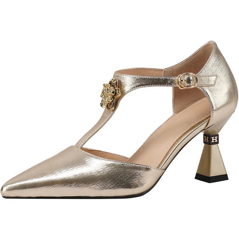 Women's silver sandals with a hollowed leather upper and pointed toe on a white background.